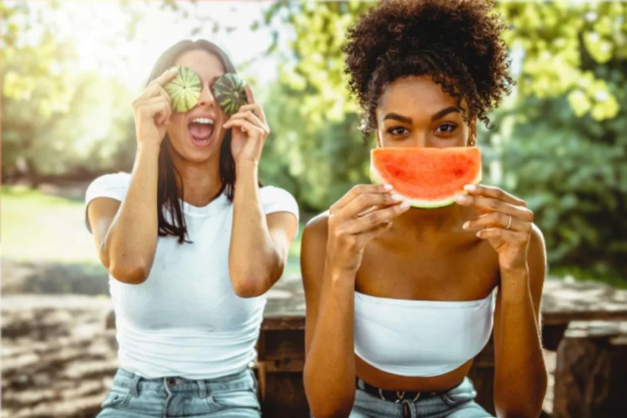 Two Gen Z females having fun with fruit